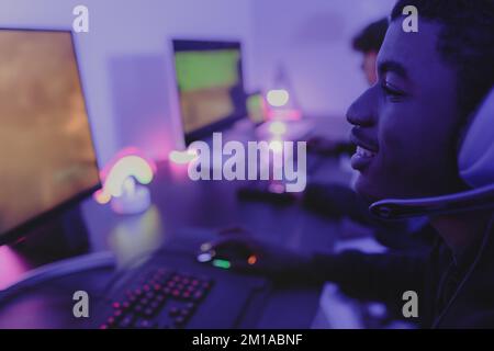 Young gamers having fun playing online video games with computer at home - Gaming entertainment and technology concept Stock Photo