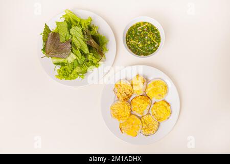 Banh can, Vietnamese mini pancake with with rice batter and egg, vietnamese food isolated on white background, top view Stock Photo