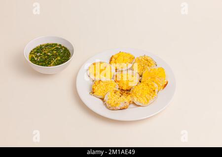 Banh can, Vietnamese mini pancake with with rice batter and egg, vietnamese food isolated on white background, perspective view Stock Photo