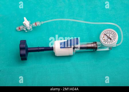 A balloon inflation device used in angioplasty procedure. Mesh metal ...