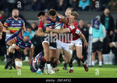 Swansea, UK. 11th Dec, 2022. Rhys Webb of the Ospreys is tackled. Heineken champions cup round one, Pool B match, Ospreys v Leicester Tigers at the Swansea.com stadium in Swansea, South Wales on Saturday 11th December 2022. pic by Andrew Orchard/Andrew Orchard sports photography/Alamy Live news Credit: Andrew Orchard sports photography/Alamy Live News Stock Photo