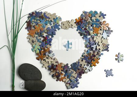 smooth rocks puzzle pieces shaped in the form of a heart zen feeling mind relaxation stimulation Stock Photo