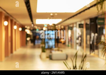 Shopping mall hall decorated for Christmas defocused. Christmas shopping blurred background. Stock Photo