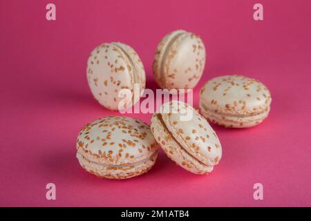 Close-up of sesame macarons cakes on red background. Stock Photo