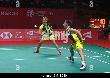 Bangkok, Thailand. 11th Dec, 2022. Dechapol Puavaranukroh (R) and Sapsiree Taerattanachai (L) of Thailand play against Zheng Si Wei and Huang Ya Qiong of China during the Badminton Mixed double Final match in the HSBC BWF World Tour Finals 2022 at Nimibutr Stadium. Zheng Si Wei and Huang Ya Qiong won over Dechapol Puavaranukroh and Sapsiree Taerattanachai 2-1 (21-19, 18-21, 21-13). Credit: SOPA Images Limited/Alamy Live News Stock Photo