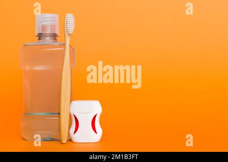 Mouthwash and other oral hygiene products on colored table top view with copy space. Flat lay. Dental hygiene. Oral care products and space for text o Stock Photo