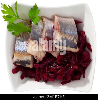 Traditional herring salad with beetroot and parsley in white plate Stock Photo