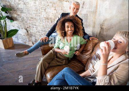 Group of  multicultural creative people having coffee break in office after meeting. Stock Photo