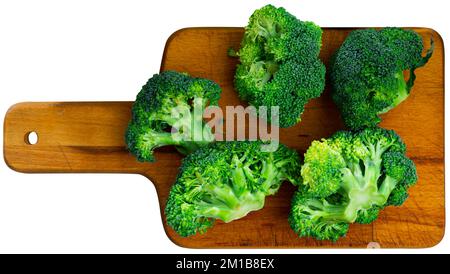Sliced fresh broccoli on kitchen board Stock Photo