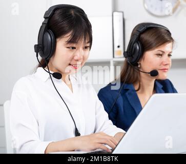 Operators working with computers in an office Stock Photo