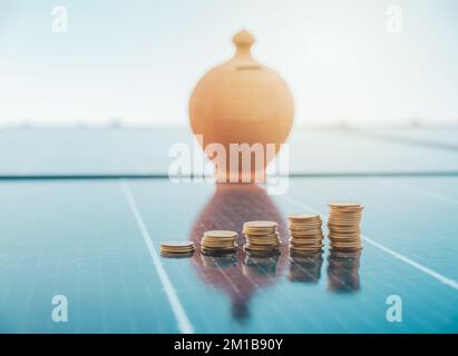Investment and money saved by using energy with solar panel Stock Photo