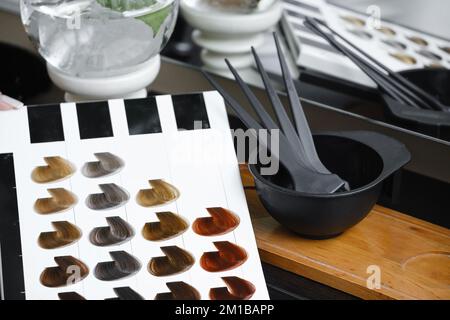 Hair color samples, hair palette and working tools in hairdressing salon. Hairdresser Working place with catalog of paint colors. Close-up  Stock Photo