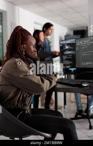 Pensive african american app developer programming code development trying to think at ideas to create coding script. It engineer working at database server in it big data agency office Stock Photo