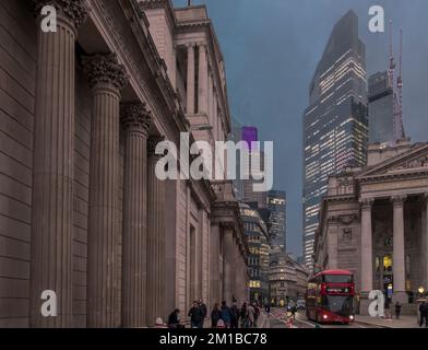 On a murky winter's evening Threadneedle Street looking east towards Bishopsgate at dusk in The City of London. Bank of England (on left). Stock Photo