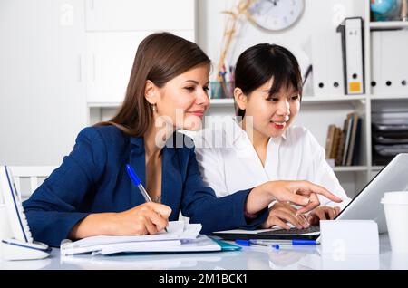 Two businesswomen working with computer in office Stock Photo