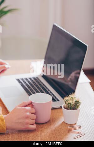 Workspace and woman's hand with coffee cup woman. Concept of women entrepreneurs, project management and planning. Stock Photo