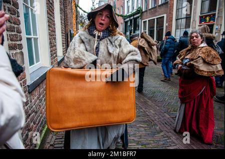 Deventer, Netherlands. 10th Dec, 2022. A woman seen showing her baggage to the camera. Each year, around this date, the 19th-century world of the English writer Charles Dickens relives in the beautiful Dutch city of Deventer. More than 950 characters from the famous books of Dickens revive Oliver Twist, Scrooge, Marley and Mr. Pickwick, etc. Wealthy ladies and gentlemen with top hats parade on the streets. This year was the 30th edition of this festival. (Photo by Ana Fernandez/SOPA Images/Sipa USA) Credit: Sipa USA/Alamy Live News Stock Photo