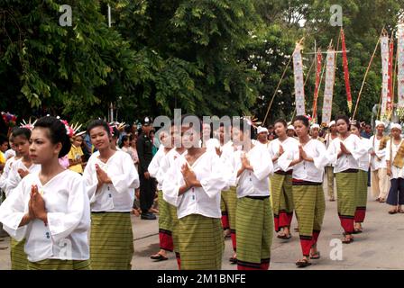 Many pretty woman on traditional dance in Tak Bat Dok Mai Festival is Ceremony of Wat Phra Buddhabat Woramahaviharn temple in Saraburi , Thailand. Stock Photo