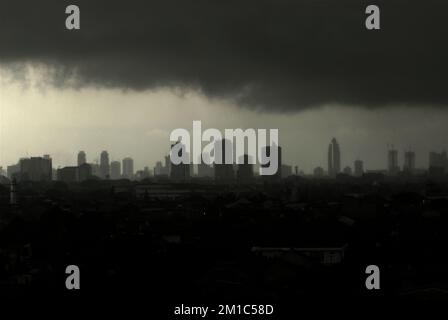 Jakarta, Indonesia. Rainclouds above the central part of Jakarta are seen from the western part of the Indonesian capital city. Stock Photo