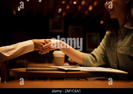 Two Businesswoman shaking hands as sign of successful negotiations. Stock Photo