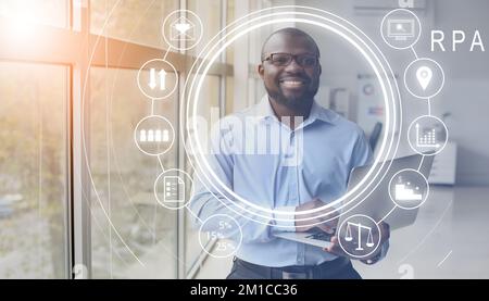 African-American businessman with laptop in office. RPA concept Stock Photo