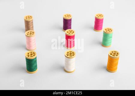 Many different thread spools on light background Stock Photo