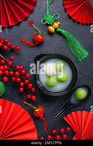 Bowl of tangyuan and Chinese decor on dark background. Dongzhi Festival ...