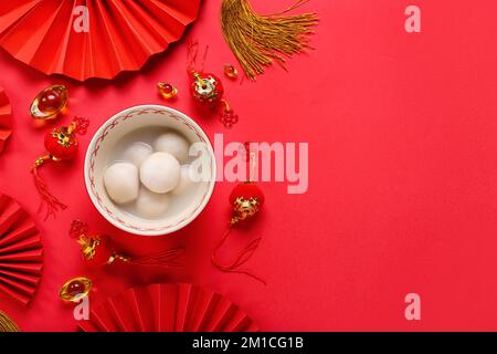 Bowl of tangyuan and Chinese decor on red background. Dongzhi Festival ...