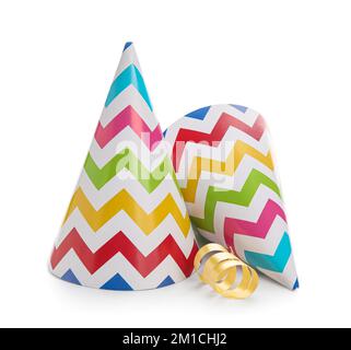 Multicolored party hats with confetti on white background Stock Photo