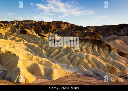 The sun rises over Zabriskie Point in Death Valley  Stock Photo