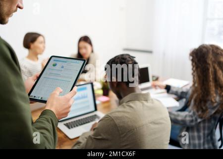 business person uses a tablet to check financial data. Graph research Stock Photo