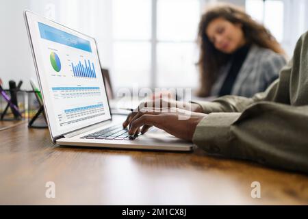 business man using a laptop to check financial data. Stock Photo