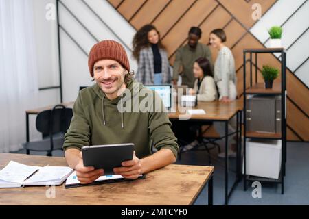 young entrepreneur analyzing financial documents in a coworking center. Stock Photo