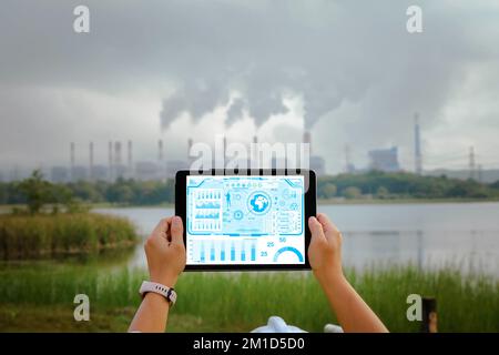 Engineers, architects or businessmen using tablets with the icon network are analyzing the operation of the coal power plant. Industry technology Stock Photo