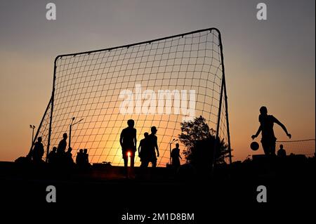 Beach soccer at sunset at Katara Beach Doha Stock Photo