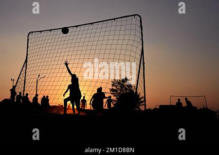 Beach soccer at sunset at Katara Beach Doha Stock Photo