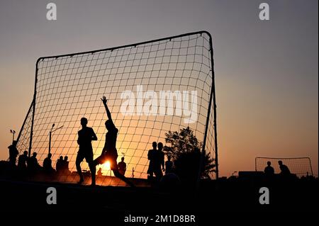 Beach soccer at sunset at Katara Beach Doha Stock Photo