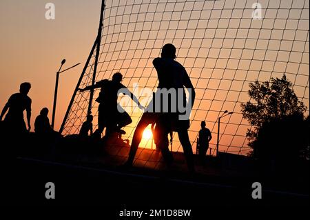 Beach soccer at sunset at Katara Beach Doha Stock Photo