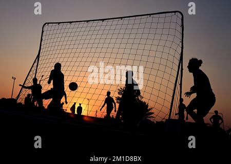 Beach soccer at sunset at Katara Beach Doha Stock Photo