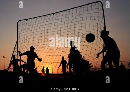 Beach soccer at sunset at Katara Beach Doha Stock Photo