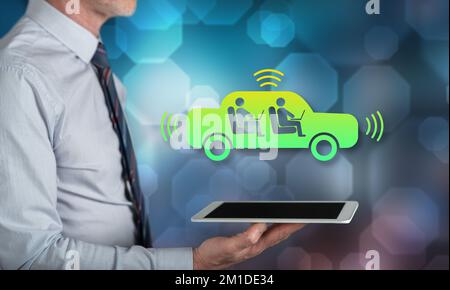 Autonomous vehicle concept above a tablet held by a man Stock Photo