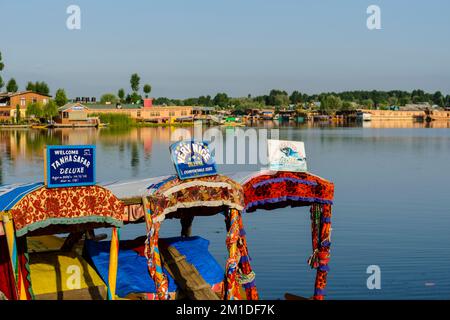 Shikaras, recognisable by artfully painted plates, are the common transport for people and goods on Dal Lake Stock Photo