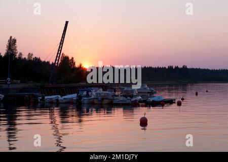 GULF OF BOTHNIA, SWEDEN ON AUGUST 04, 2014. Summer sunset. Small harbor along the coast. Bridge, and boats. Editorial use. Stock Photo