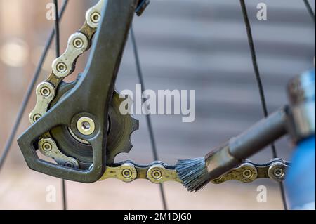 Cleaning a bicycle chain and oiling the chain for durability Stock Photo