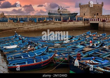 Traditional blue fishing boats in the fishing port, evening sky, Essaouira, Morocco, Africa Stock Photo