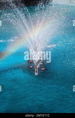 A water fountain sprinkling water in the view Stock Photo