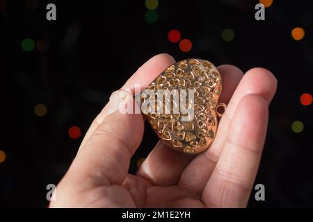 Heart shape icon in hand on bokeh light Stock Photo