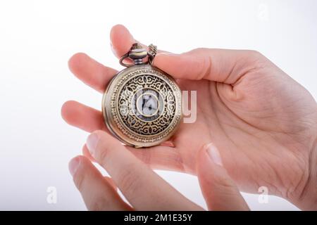 Hand holding a retro styled pocket watch in hand Stock Photo