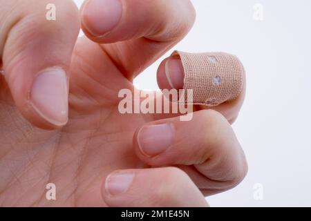 Finger in white bandage on a white background Stock Photo