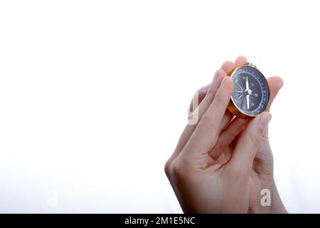 Isolated compass in child's hand on a white background Stock Photo